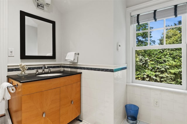 5 Club Way, Mount Kisco, NY 10549 - bathroom featuring tile walls, vanity, healthy amount of natural light, and a wainscoted wall