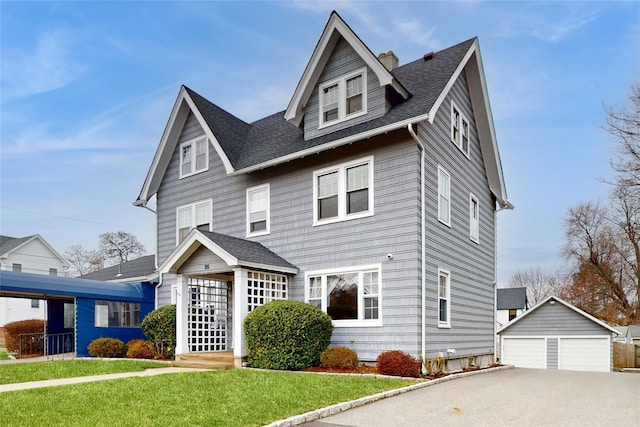 55 Teller Ave, Beacon, NY 12508 - view of front of property with an outbuilding, a front lawn, a detached garage, and roof with shingles