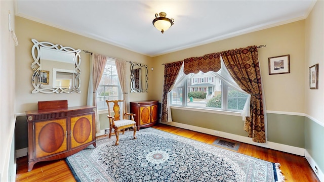 55 Teller Ave, Beacon, NY 12508 - sitting room with wood finished floors, baseboards, crown molding, and cooling unit