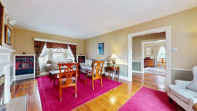 55 Teller Ave, Beacon, NY 12508 - living room with a fireplace with flush hearth, healthy amount of natural light, wood finished floors, baseboards, and ornamental molding