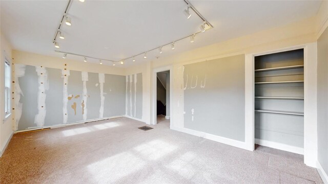 55 Teller Ave, Beacon, NY 12508 - unfurnished bedroom with track lighting, carpet flooring, and baseboards
