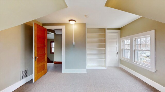 55 Teller Ave, Beacon, NY 12508 - unfurnished room featuring baseboards, light carpet, and built in shelves