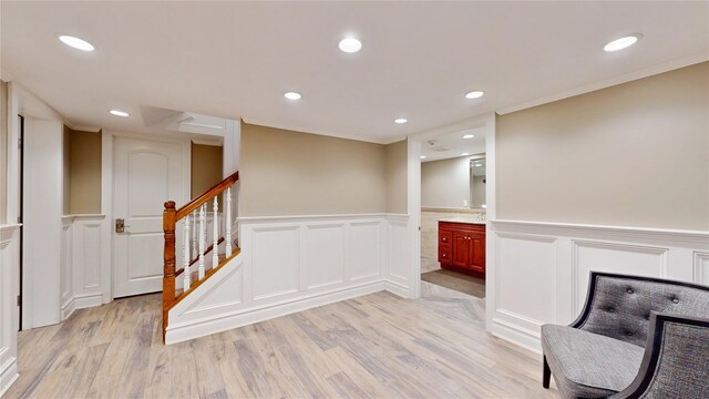 55 Teller Ave, Beacon, NY 12508 - unfurnished room with a decorative wall, wainscoting, light wood-style floors, recessed lighting, and stairs