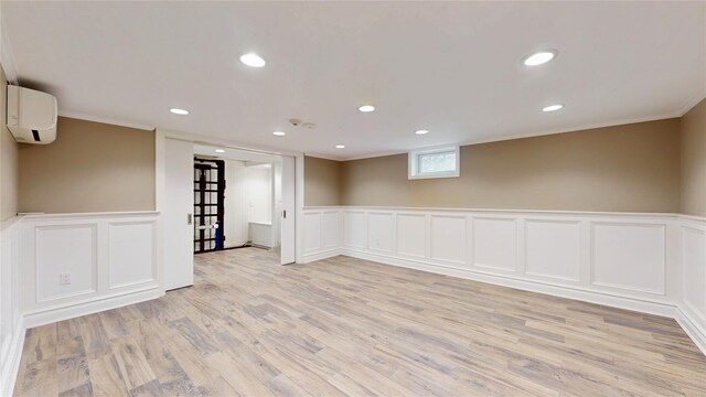 55 Teller Ave, Beacon, NY 12508 - below grade area featuring a decorative wall, a wall mounted air conditioner, light wood-style flooring, wainscoting, and ornamental molding