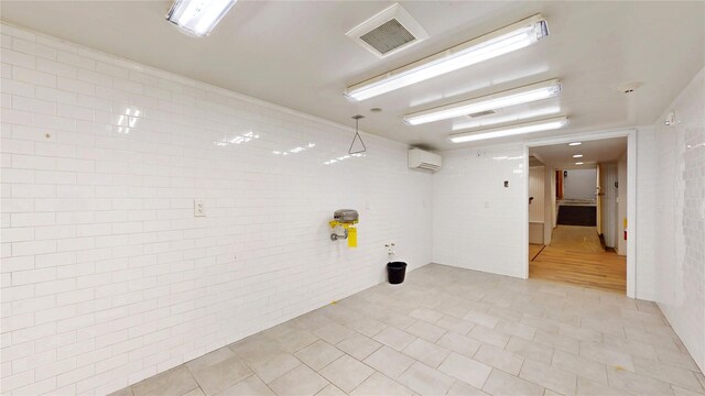55 Teller Ave, Beacon, NY 12508 - empty room with a wall unit AC, light tile patterned floors, and tile walls