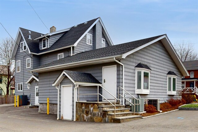 55 Teller Ave, Beacon, NY 12508 - view of front facade with central AC, roof with shingles, and fence