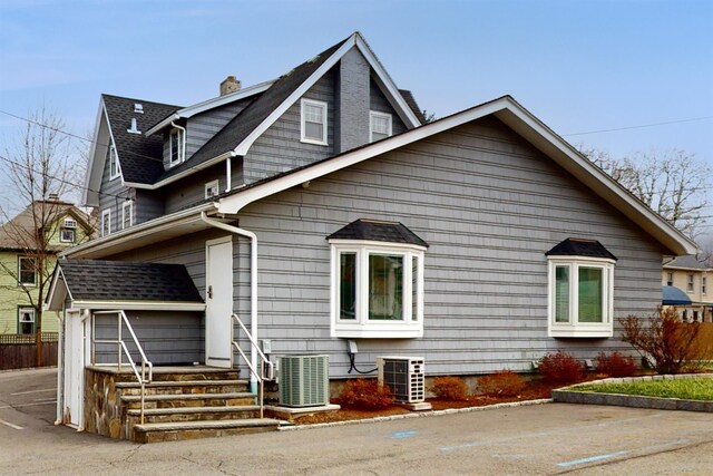 55 Teller Ave, Beacon, NY 12508 - view of home's exterior featuring central AC, fence, a chimney, and an outbuilding