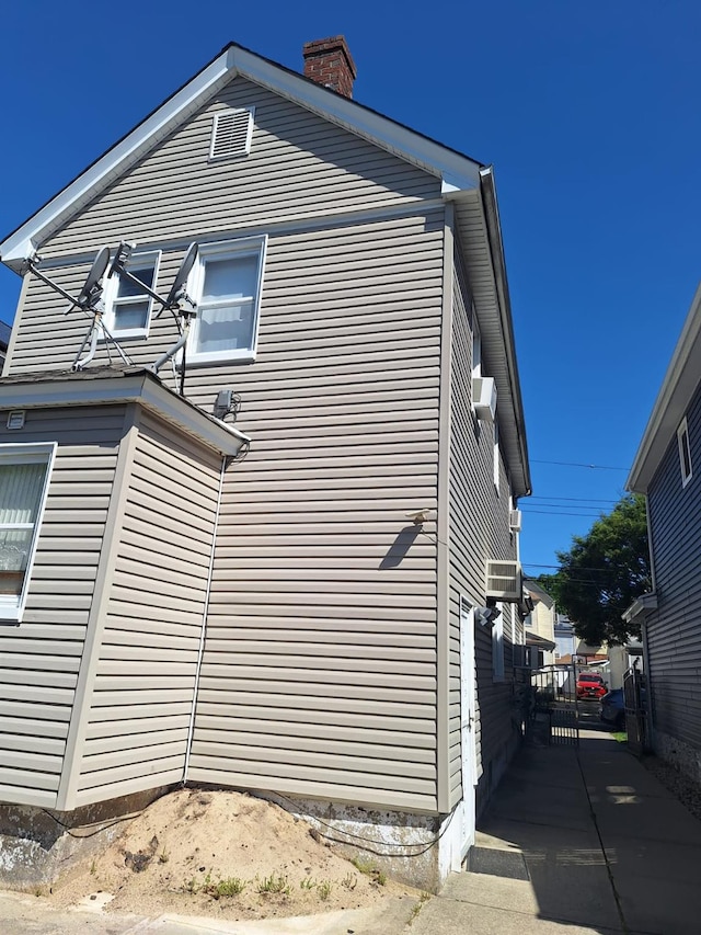 237-20 93rd Ave, Bellerose, NY 11426 - view of property exterior with a chimney