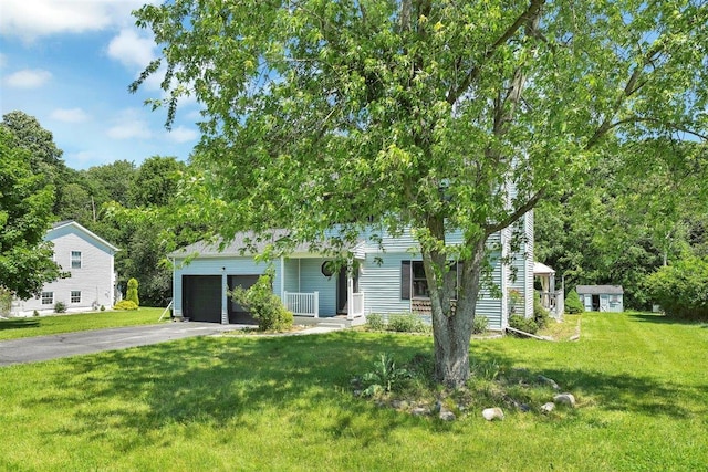 54 Capital Dr, Washingtonville, NY 10992 - obstructed view of property with asphalt driveway, a front yard, and a garage