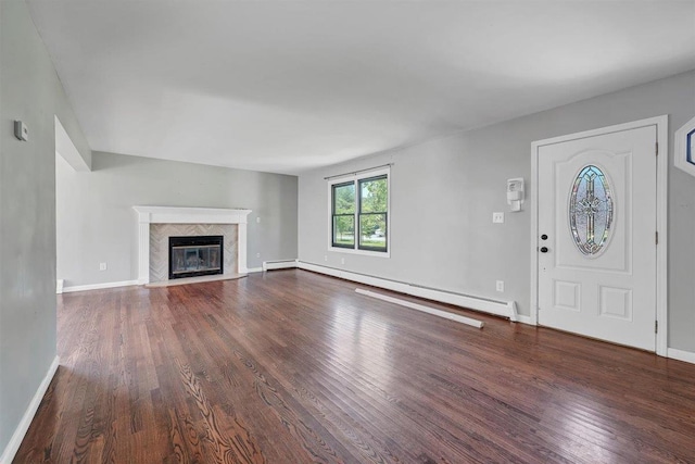 54 Capital Dr, Washingtonville, NY 10992 - unfurnished living room with wood finished floors, baseboard heating, baseboards, and a fireplace
