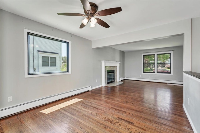 54 Capital Dr, Washingtonville, NY 10992 - unfurnished living room featuring a baseboard radiator, wood finished floors, and a ceiling fan