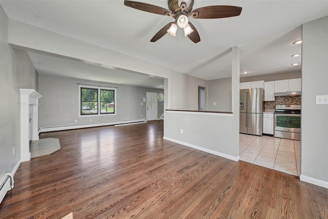 54 Capital Dr, Washingtonville, NY 10992 - unfurnished living room featuring light wood-style floors, a ceiling fan, baseboards, a baseboard heating unit, and recessed lighting