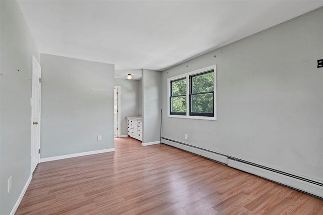 54 Capital Dr, Washingtonville, NY 10992 - spare room with wood finished floors, a baseboard radiator, and baseboards
