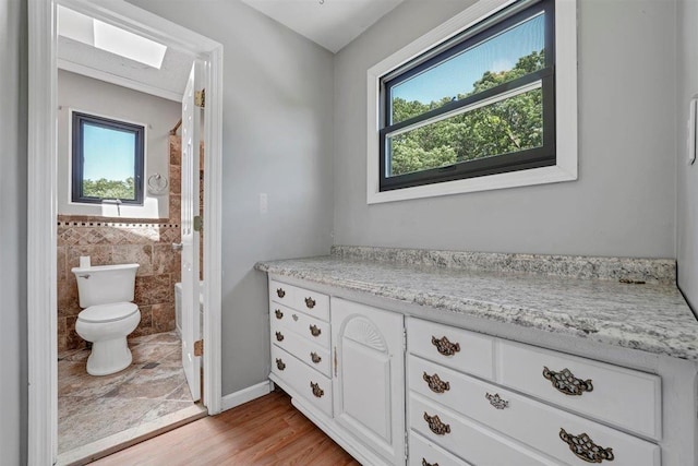 54 Capital Dr, Washingtonville, NY 10992 - full bath with toilet, wood finished floors, vanity, and tile walls