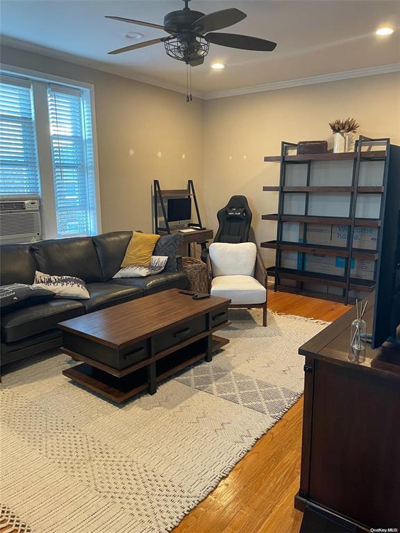 185 Atlantic Ave Unit C-1, Lynbrook, NY 11563 - living room featuring a ceiling fan, wood finished floors, cooling unit, ornamental molding, and recessed lighting