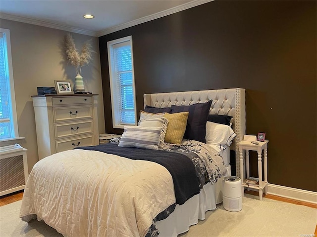 185 Atlantic Ave Unit C-1, Lynbrook, NY 11563 - bedroom featuring wood finished floors, baseboards, recessed lighting, ornamental molding, and radiator heating unit