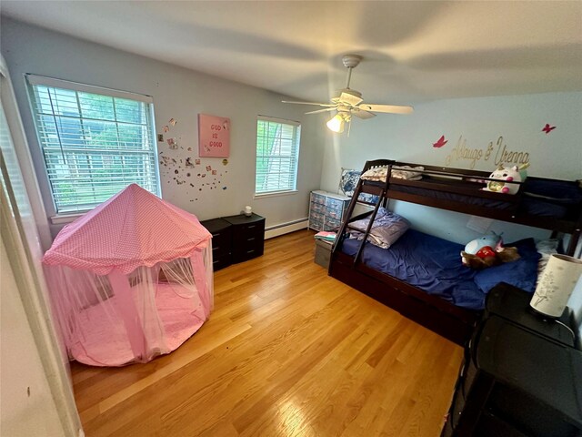 202 Doxbury Ln, Suffern, NY 10901 - bedroom featuring a baseboard radiator, light wood-style flooring, and a ceiling fan