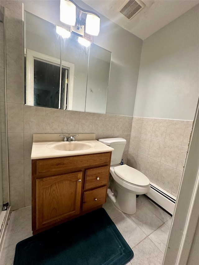 202 Doxbury Ln, Suffern, NY 10901 - bathroom featuring baseboard heating, tile walls, vanity, toilet, and tile patterned flooring