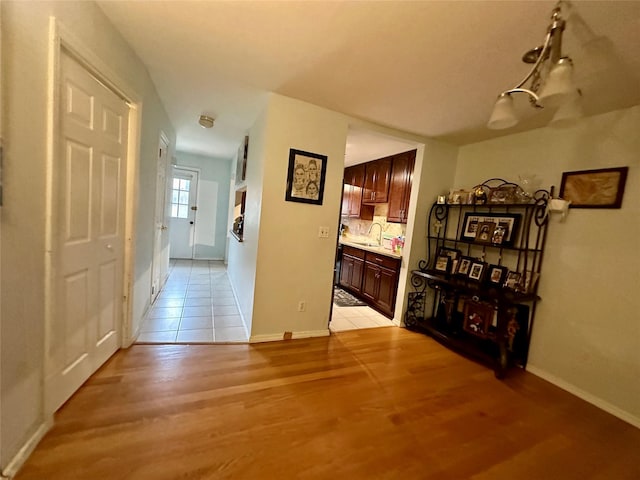 202 Doxbury Ln, Suffern, NY 10901 - hall with light wood-style flooring, a sink, and baseboards