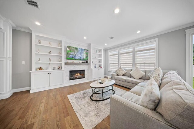 1427 Bellmore Rd, North Bellmore, NY 11710 - living room featuring crown molding, a large fireplace, light wood finished floors, baseboards, and recessed lighting