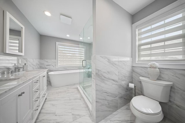 1427 Bellmore Rd, North Bellmore, NY 11710 - bathroom with tile walls, marble look tiles, a shower stall, toilet, and wainscoting