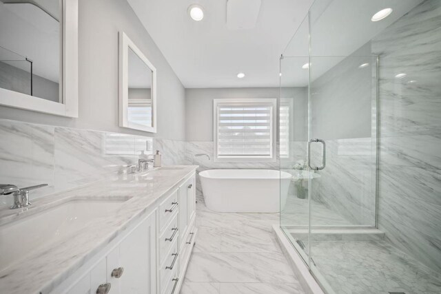 1427 Bellmore Rd, North Bellmore, NY 11710 - bathroom featuring tile walls, a shower stall, a freestanding bath, recessed lighting, and double vanity
