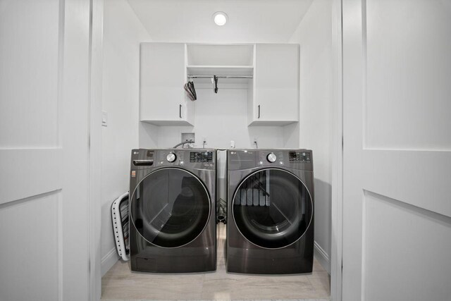 1427 Bellmore Rd, North Bellmore, NY 11710 - laundry area featuring separate washer and dryer, baseboards, and cabinet space