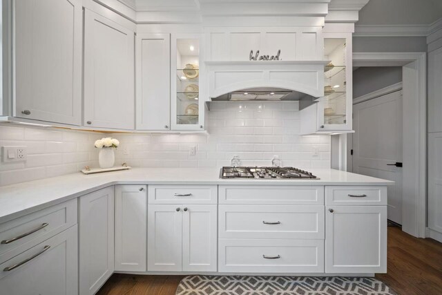 1427 Bellmore Rd, North Bellmore, NY 11710 - kitchen with stainless steel gas stovetop, dark wood-style flooring, light countertops, decorative backsplash, and crown molding