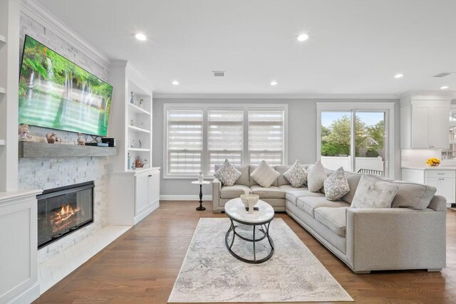 1427 Bellmore Rd, North Bellmore, NY 11710 - living area featuring crown molding, plenty of natural light, recessed lighting, a fireplace, and wood finished floors