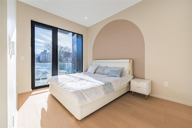 3116 21st St Unit Ph2B, Astoria, NY 11106 - bedroom featuring access to exterior, light wood-type flooring, baseboards, and recessed lighting