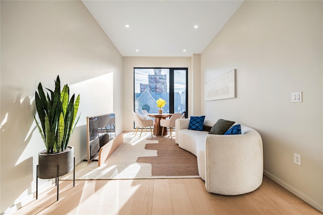 3116 21st St Unit Ph2B, Astoria, NY 11106 - living room featuring wood finished floors, baseboards, vaulted ceiling, and recessed lighting