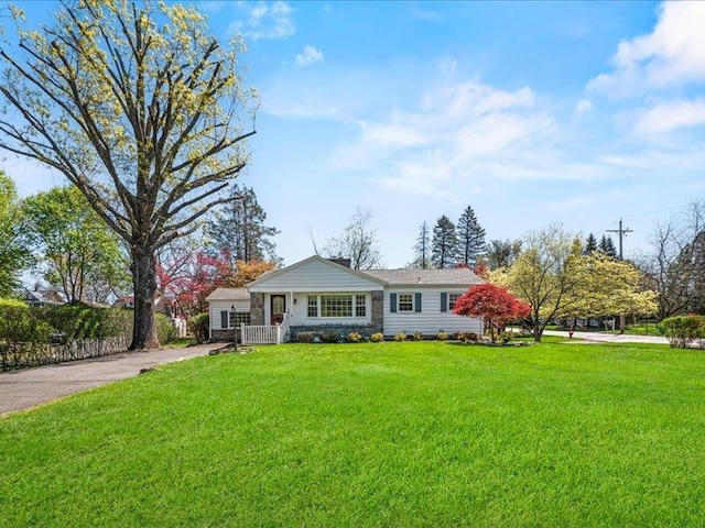 view of front facade with a front lawn and a chimney