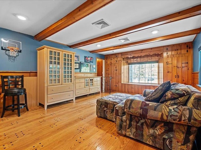 living room with wooden walls, beam ceiling, hardwood / wood-style floors, recessed lighting, and wainscoting