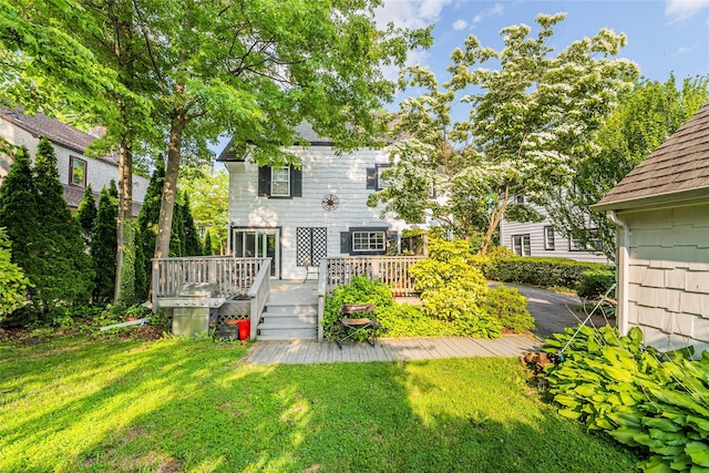 5 Cary Rd, Great Neck, NY 11021 - rear view of house featuring a lawn, a deck, and a shingled roof