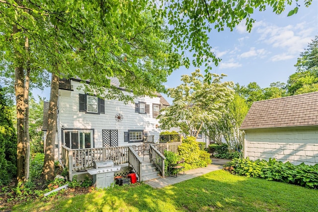 5 Cary Rd, Great Neck, NY 11021 - rear view of house with a deck, a yard, and roof with shingles