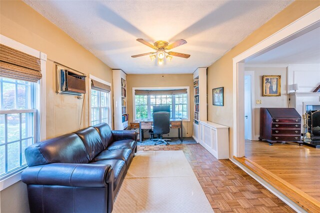 5 Cary Rd, Great Neck, NY 11021 - living area with an office area, a ceiling fan, a wall mounted AC, and baseboards