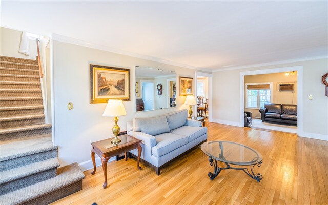 5 Cary Rd, Great Neck, NY 11021 - living area with stairway, light wood-style floors, crown molding, a wall mounted AC, and baseboards