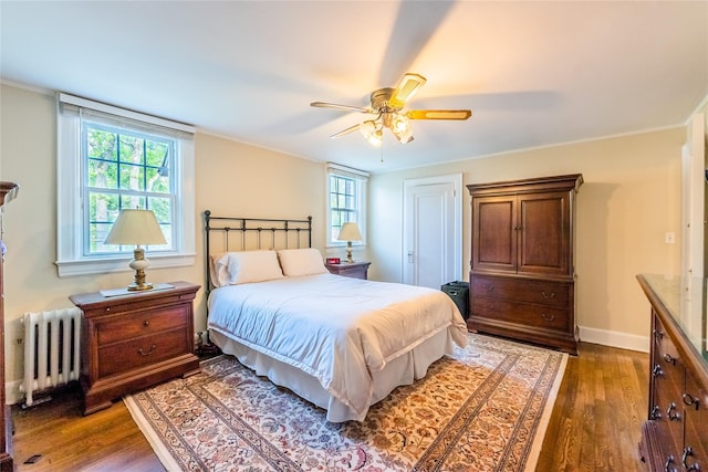 5 Cary Rd, Great Neck, NY 11021 - bedroom featuring radiator, multiple windows, wood finished floors, a ceiling fan, and crown molding