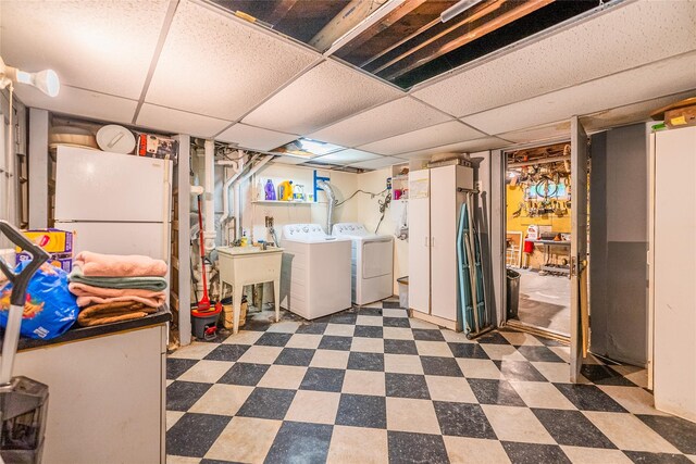 5 Cary Rd, Great Neck, NY 11021 - finished below grade area with washing machine and dryer, dark flooring, and a paneled ceiling