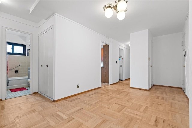 21-50 33rd Rd Unit 12Ab, Astoria, NY 11106 - spare room featuring baseboards and a chandelier
