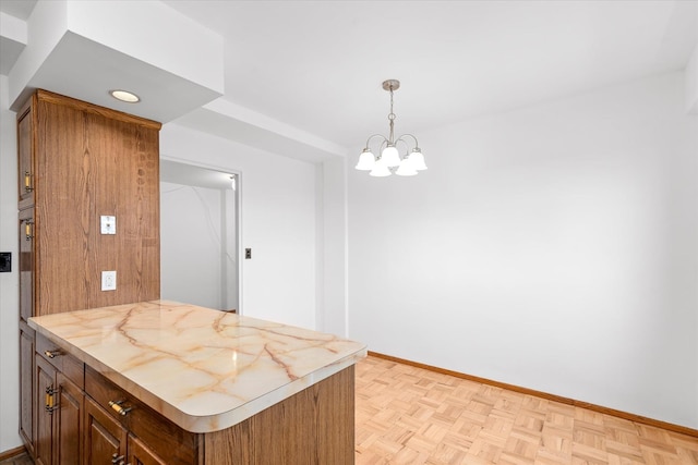 21-50 33rd Rd Unit 12Ab, Astoria, NY 11106 - kitchen with baseboards, decorative light fixtures, a peninsula, and a chandelier