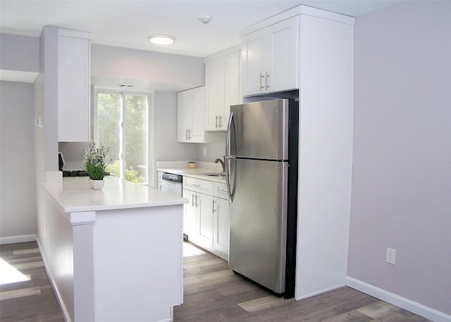 7 Laramie Ct Unit 7, Coram, NY 11727 - kitchen with freestanding refrigerator, wood finished floors, white cabinets, and light countertops