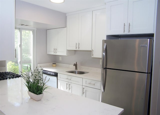 7 Laramie Ct Unit 7, Coram, NY 11727 - kitchen featuring freestanding refrigerator, a sink, dishwasher, and white cabinets