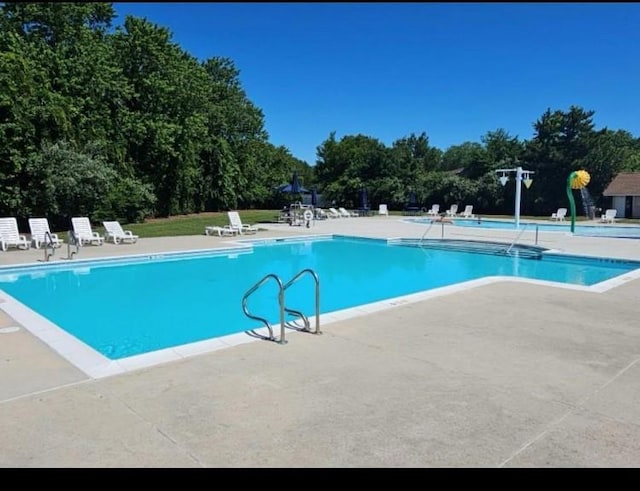 7 Laramie Ct Unit 7, Coram, NY 11727 - community pool featuring a patio area and view of scattered trees