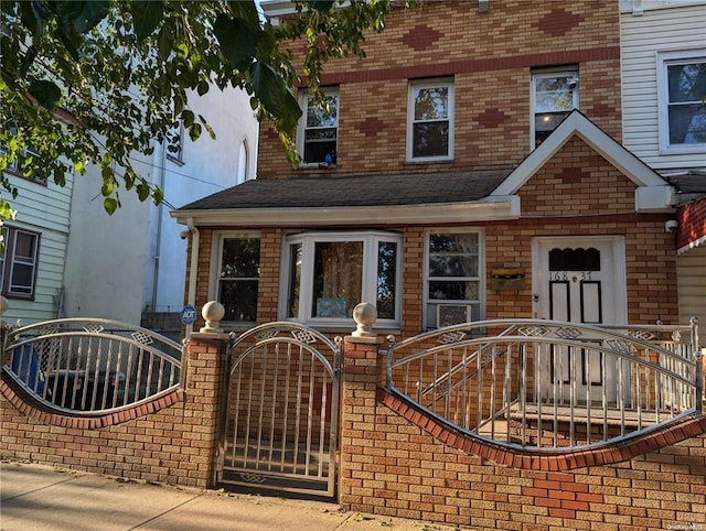 16837 90th Ave, Jamaica, NY 11432 - view of front of home with a gate, roof with shingles, and brick siding