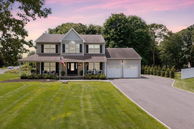 2 Moor Ln, East Patchogue, NY 11772 - view of front of house with covered porch, an attached garage, driveway, and a yard