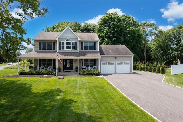 2 Moor Ln, East Patchogue, NY 11772 - colonial house featuring a garage, a porch, driveway, and a front yard
