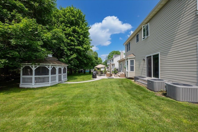 2 Moor Ln, East Patchogue, NY 11772 - view of grassy yard with central air condition unit, a gazebo, and a patio area