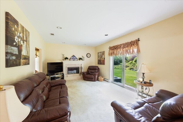 2 Moor Ln, East Patchogue, NY 11772 - living area with carpet floors, a glass covered fireplace, and baseboard heating