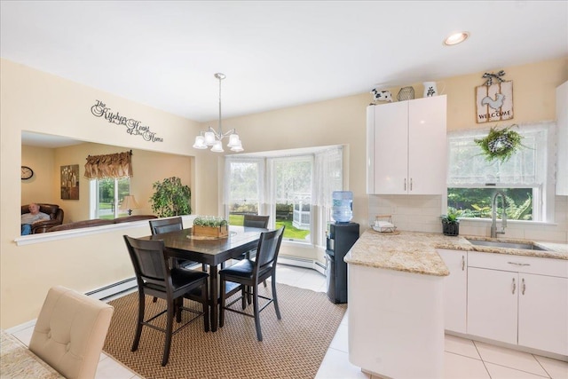 2 Moor Ln, East Patchogue, NY 11772 - dining space with a chandelier, healthy amount of natural light, a baseboard heating unit, light tile patterned flooring, and recessed lighting